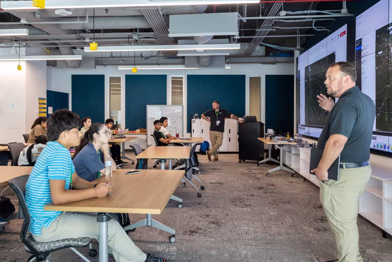 Instructor teaches in class full of students