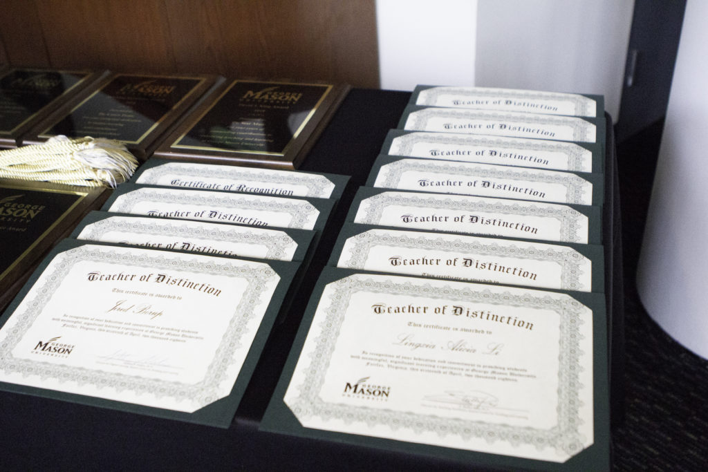 Award certificates stacked on a table