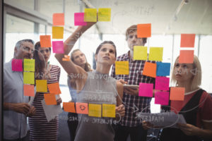 Group of business people planning with adhesive notes in creative office